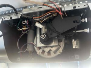 During a garage door tuneup in Austin the garage door opener, garage door spring, tracks, rollers and spools are all checked.