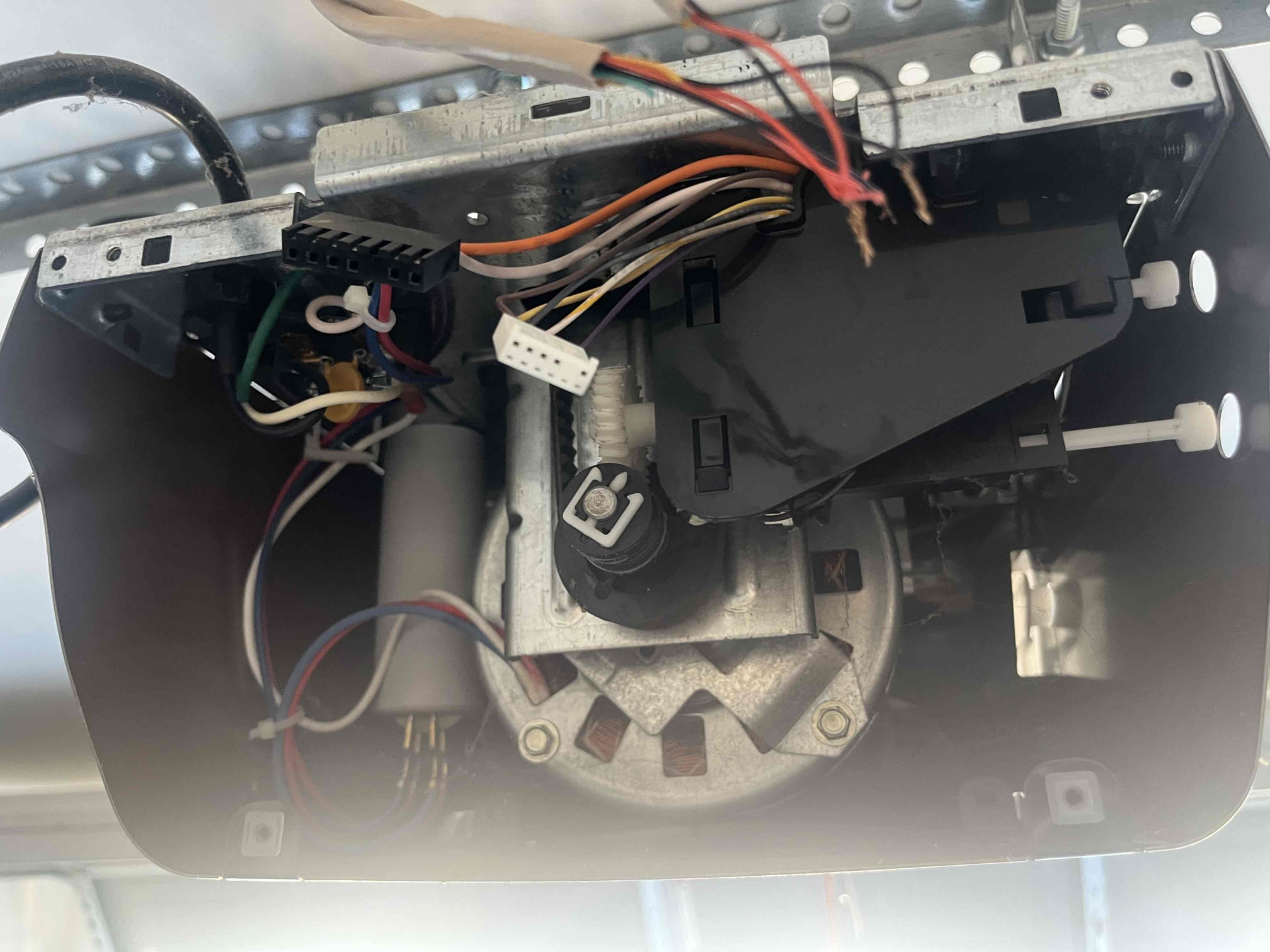 During a garage door tuneup in Austin the garage door opener, garage door spring, tracks, rollers and spools are all checked.