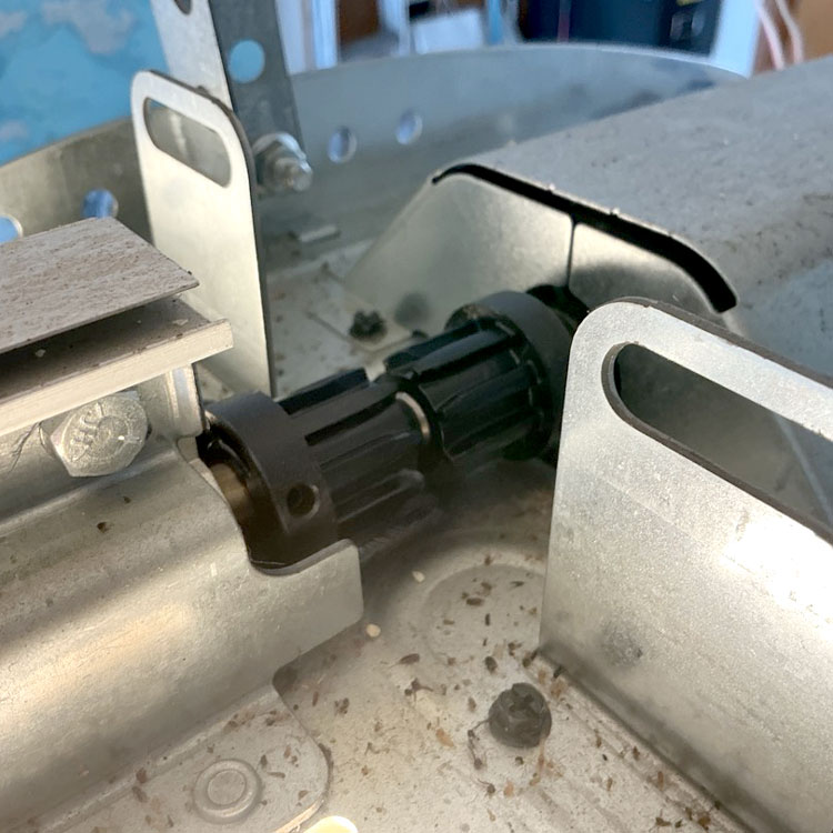 Broken garage door opener coupler before replacement in Benbrook, Texas.