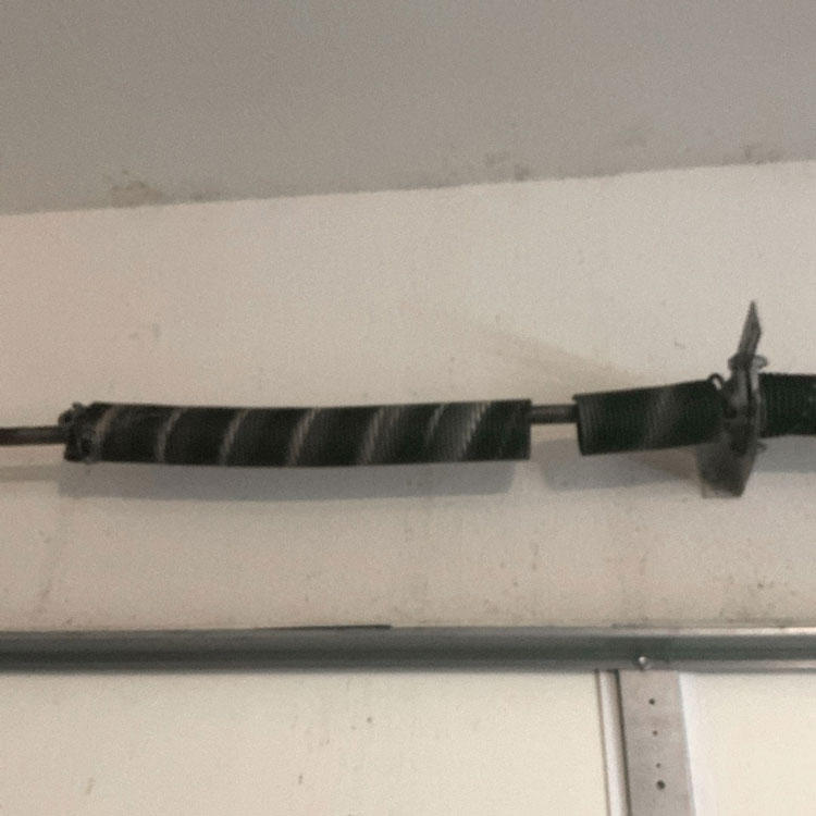 Broken torsion spring on a four-spring garage door system at a home in Dallas, TX.