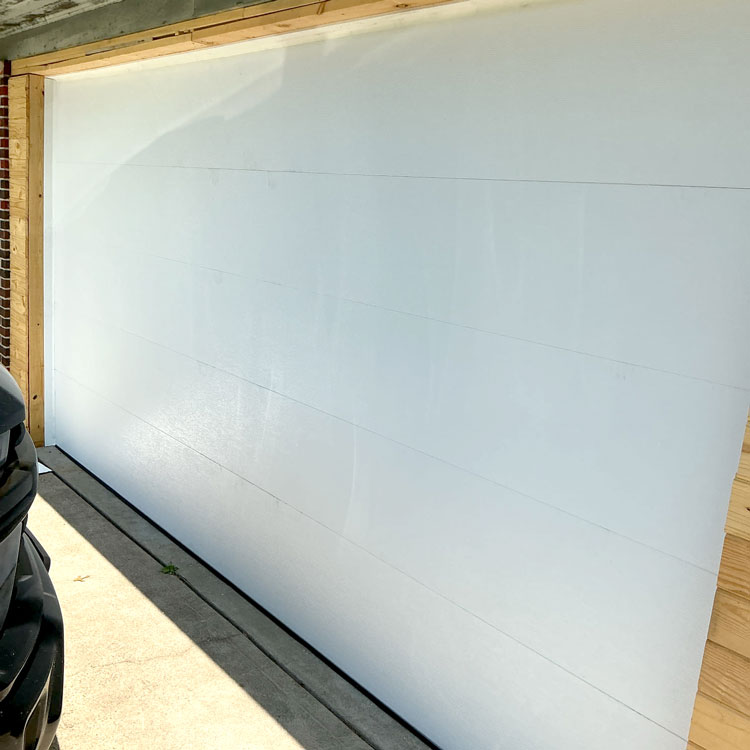 Modern white flush panel garage door installed on a converted carport in Fort Worth, Texas.