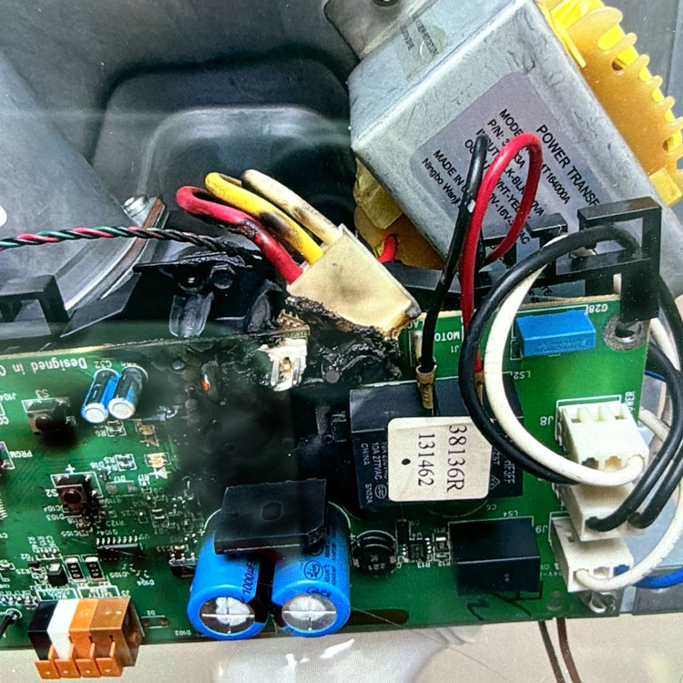 Melted garage door opener circuit board and burned wiring caused by a power surge in San Antonio, TX